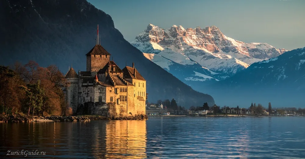 The Chateau de Chillon with the snowy Alps across Lake Geneva