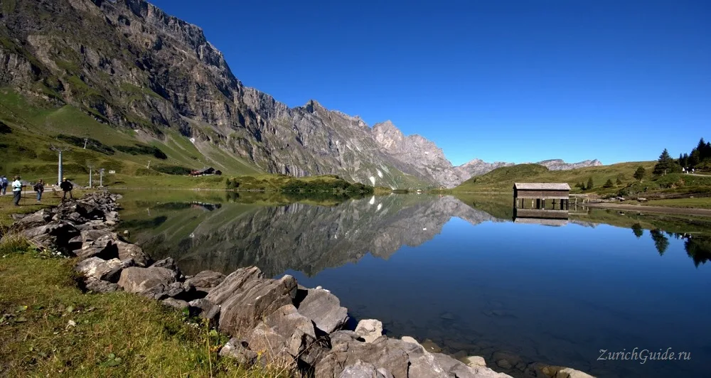 A mountain lake reflecting the peaks above Engelberg