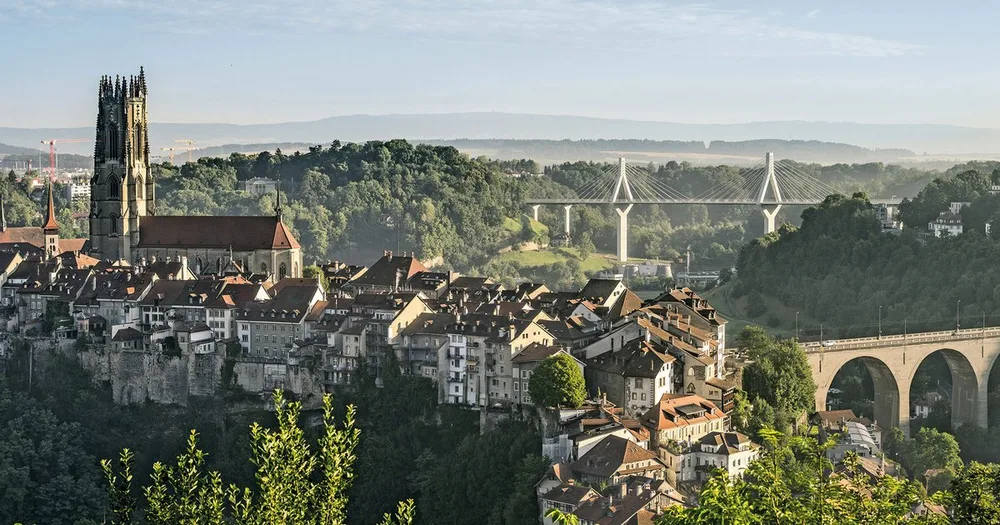 The old town of Fribourg dropping to the river, with the cathedral tower above
