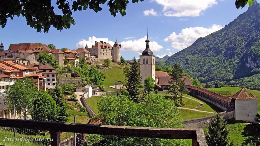 The hilltop town of Gruyeres with its castle and the mountains behind
