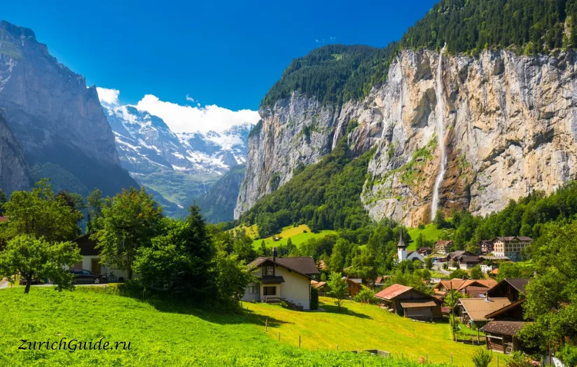 The Lauterbrunnen valley with cliffs on both sides and a waterfall